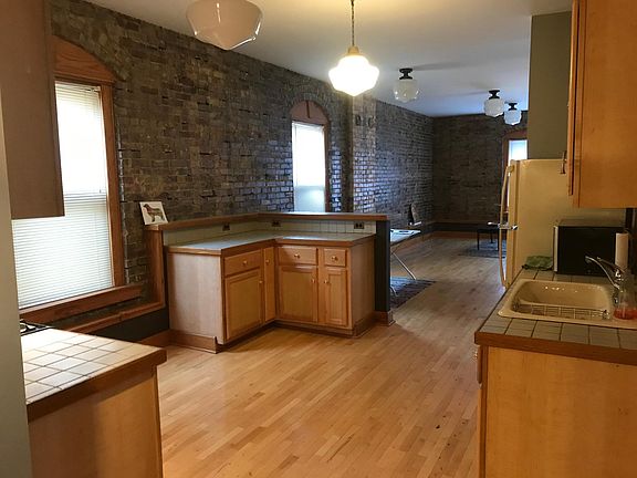 View of the kitchen and the living room in the back round, big space