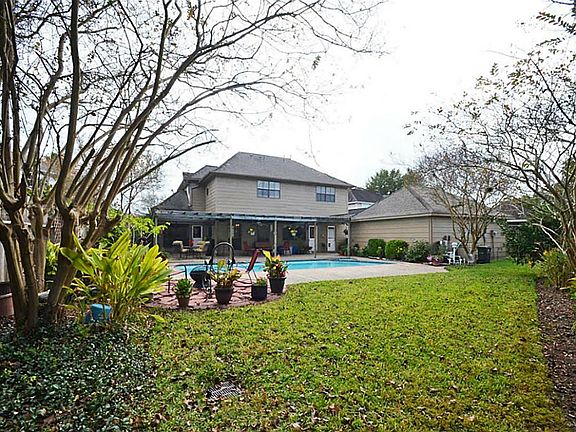 Ample back yard with swimming pool, and various patio areas for easy entertaining