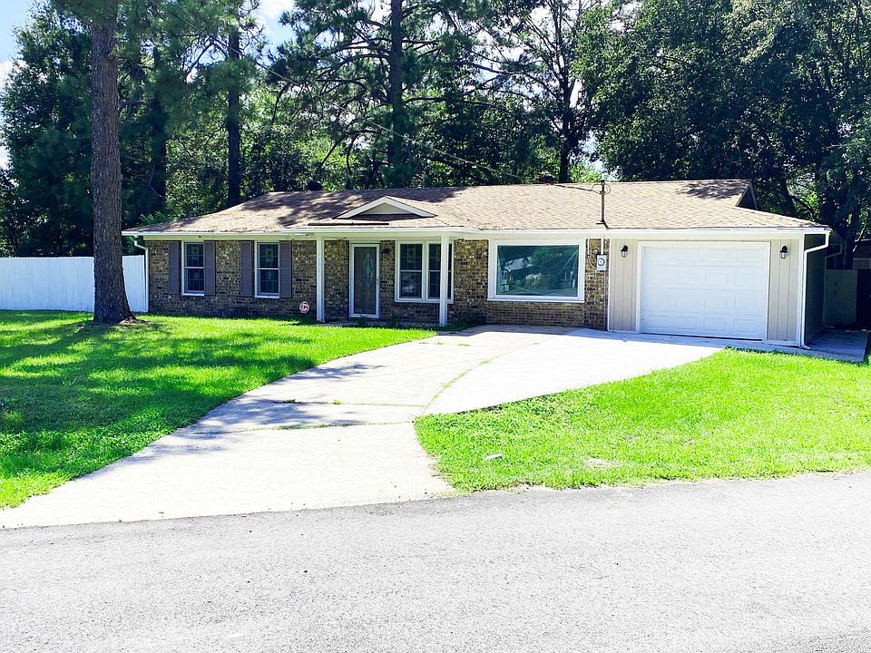 Front yard and large driveway and parking pad
