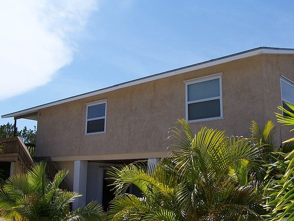 Side of home with fenced area