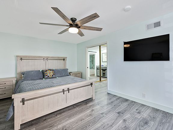 Master bedroom with flatscreen ROKU TV. Spectrum is the local TV App