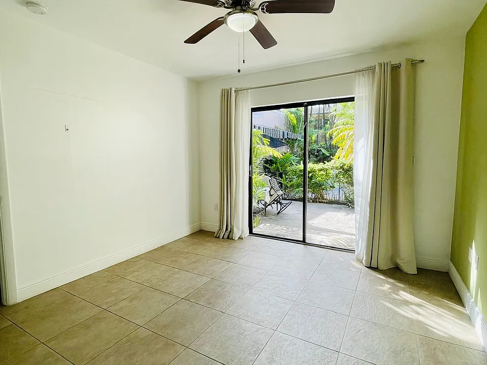 liding glass doors. The bedroom also opens to a beautiful private patio, and its window overlooks and connects directly to the pool area