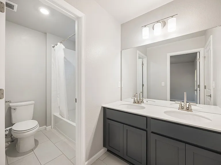 Jack and Jill secondary bath with tub/shower combo and double sinks