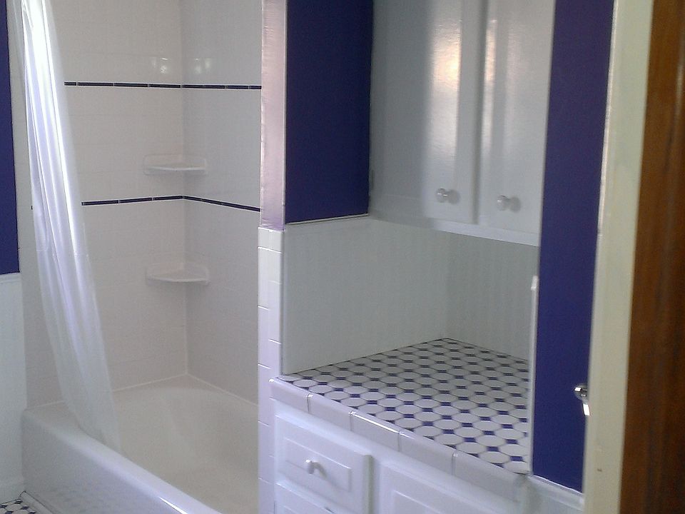 Tub and storage area in batheroom.