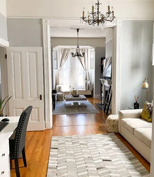 View from 2nd bedroom into living room through pocket doors, which can be closed for privacy if using for bedroom.