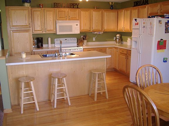 Huge kitchen with lots of cabinet storage and breakfast bar opens to the left 