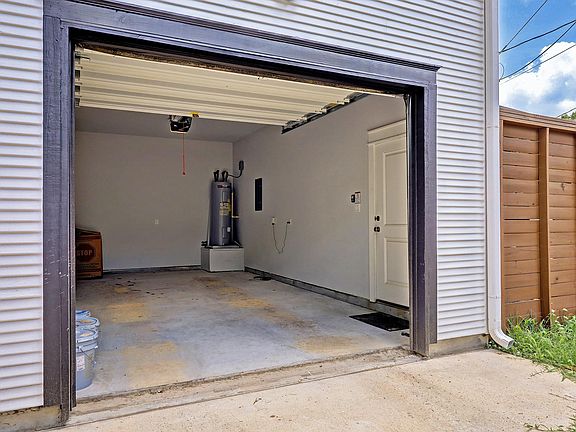 Unique one car garage provides secure parking and private entrance through alley access.