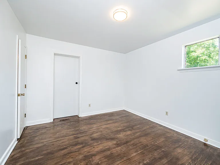 Primary bedroom with attached half bath