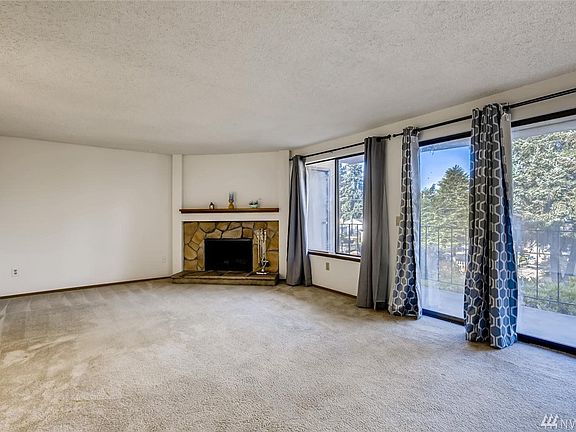 The light & bright living room with a wall of windows.