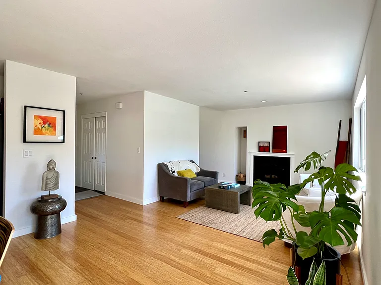 Living room with bamboo flooring. Decorative fireplace only.