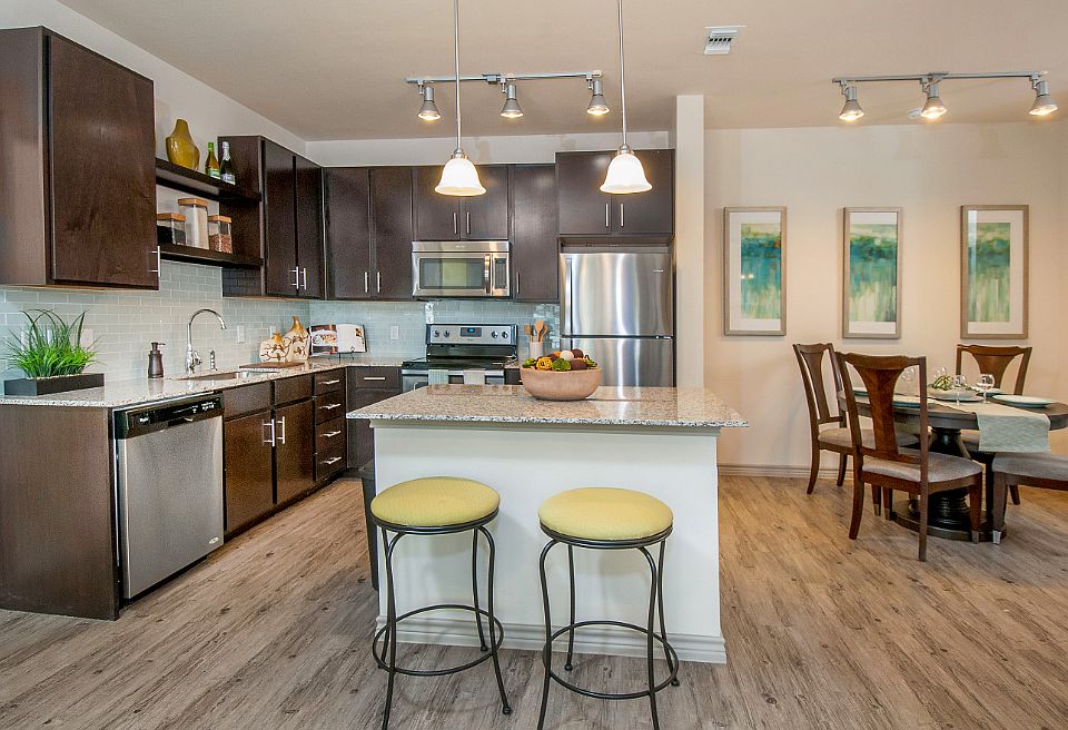 Kitchen with island, bar seating & dining room