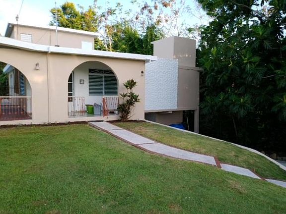 Front of the house with view to car garage and upper apartment.
