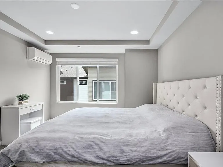 Master bedroom with plentiful sunlight, walk-in closet, upgraded bath cabinets, and shower.
