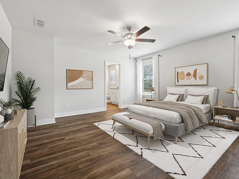 Primary Bedroom with king size bed and large window letting in nice natural light.