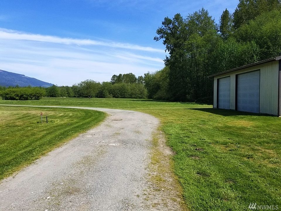 Looking East from Fruitdale Rd. Shop is to the right and driveway turns North towards the adjoining 5.5 Acres with house, garage and barn - that parcel is also available for sale. 