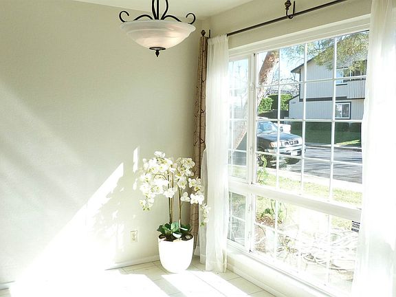 The dining area is adjacent to a large window that brightens the room.