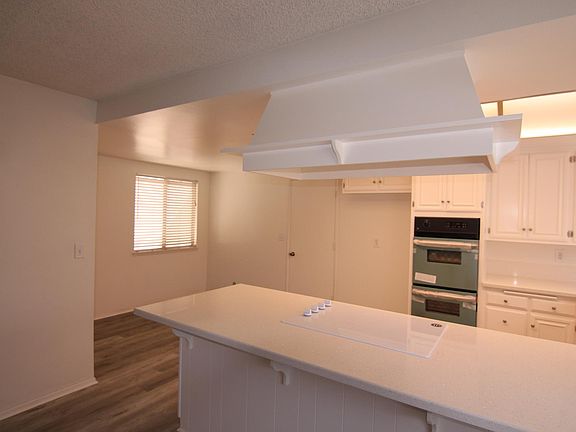 From dining area looking to kitchen breakfast bar and breakfast nook behind it.