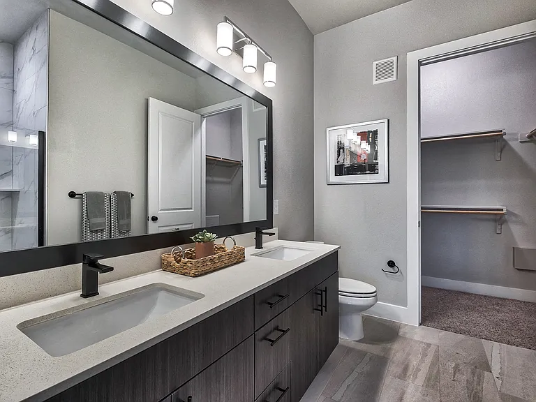 Master bathrooms feature dual vanity sinks, framed mirrors and upgraded lighting