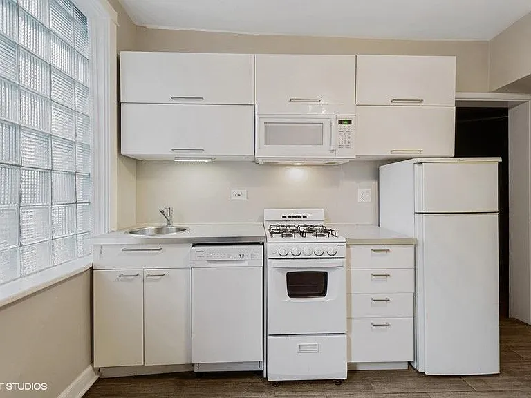 White on white kitchen with dishwasher & microwave