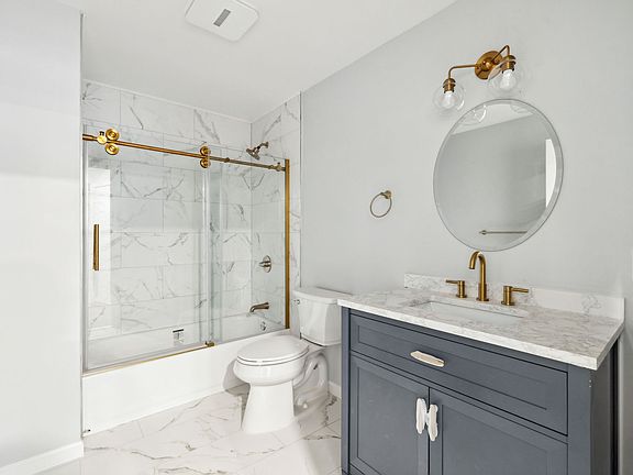 Full Bathroom featuring gold accents and Porcelain Tiles throughout
