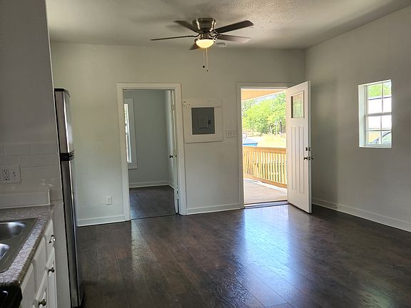 Front door on right, second bedroom door on left, kitchen at back left.