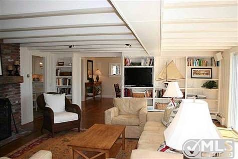 living room with built-ins and door to dining room