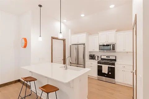 Kitchen area with new appliances and door to mudroom