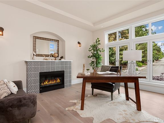 The homes spacious & bright office with cozy fireplace.