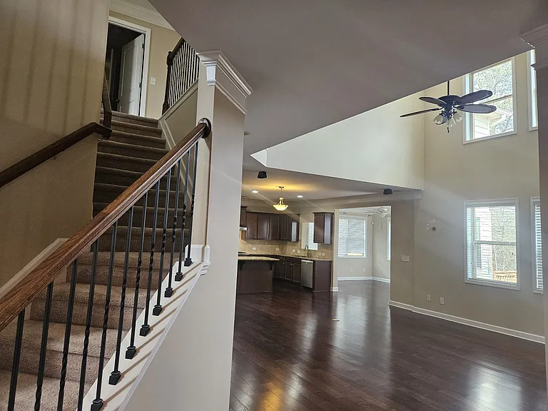Living hall, sunroom and kitchen - view from front foyer walk way