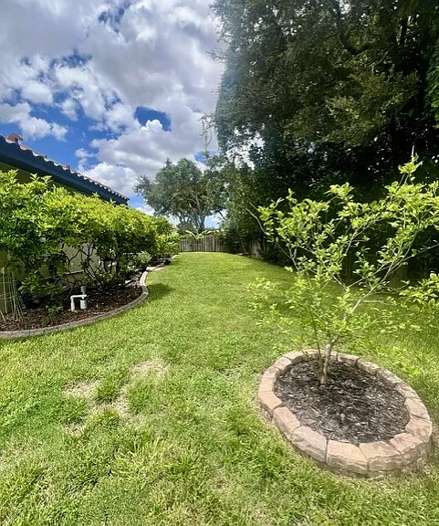 Backyard fully fenced. Landscape maintenance included. Myer's lemon tree and banana trees. True Florida living!!