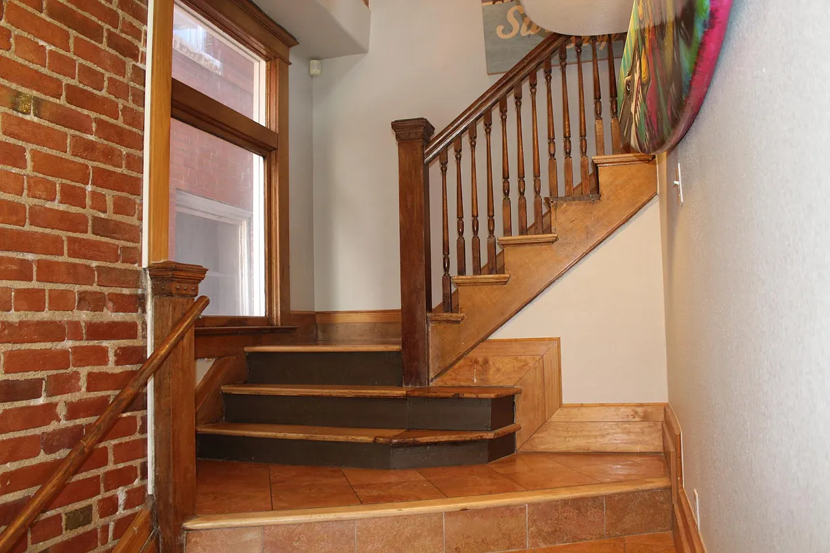 Front entrance with exposed brick and 1906 banister - 1917 E 21st Ave