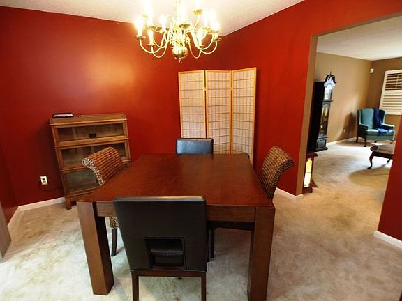 Spacious formal dining room looks out to the private patio
