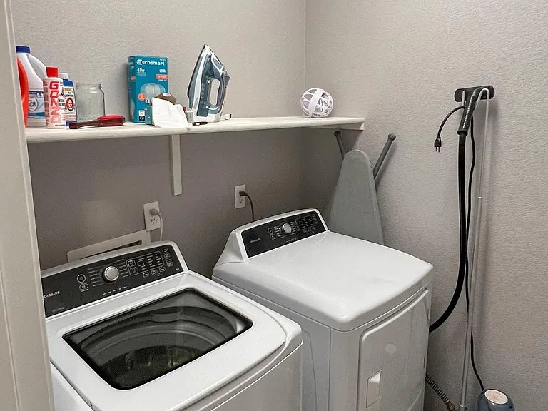 Laundry room. Washing machine and dryer are provided.
