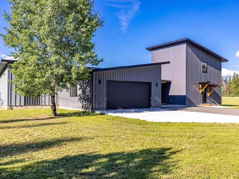 Beautiful Montana modern home set on over 2 acres and surrounded by breathtaking mountain views, offering a peaceful blend of modern design, open space, and Montana's natural beauty just minutes from Whitefish outdoor recreation and adventure.