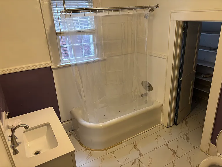 Antique curved cast iron tub with shower, massive closet off second bath