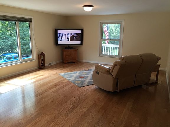 Expansive Living Room with new hardwood
						:
						Expansive Living room with views of the surrounding woods and lawn.