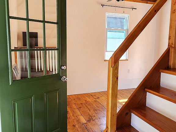 Front door and steps to second floor.
