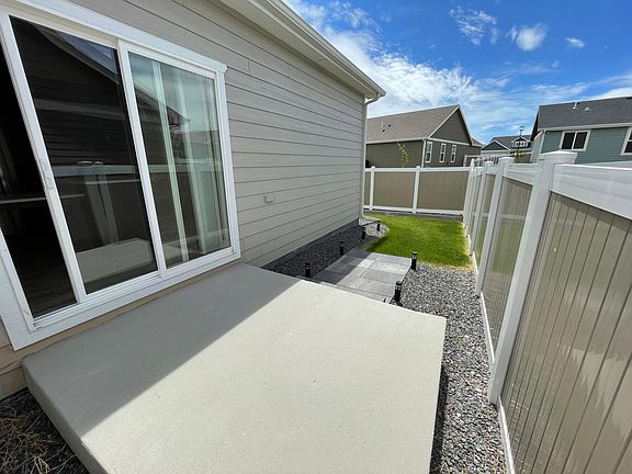 Sliding glass door from kitchen to little patio - perfect spot for your grill!
