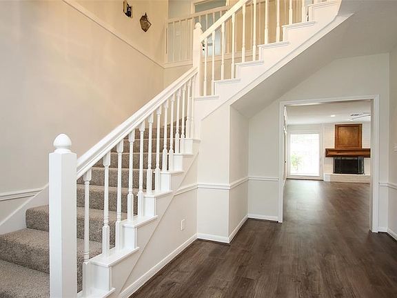 As you enter, the main staircase is to the left and has fresh updated carpet. The vinyl wood-look flooring was just installed, as well, and flows throughout most of the main level of the home.