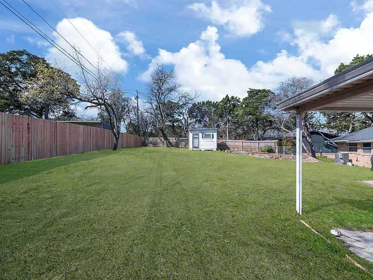 Backyard with sprinkler system and small storage building/Man Cave or She Shed in the backyard