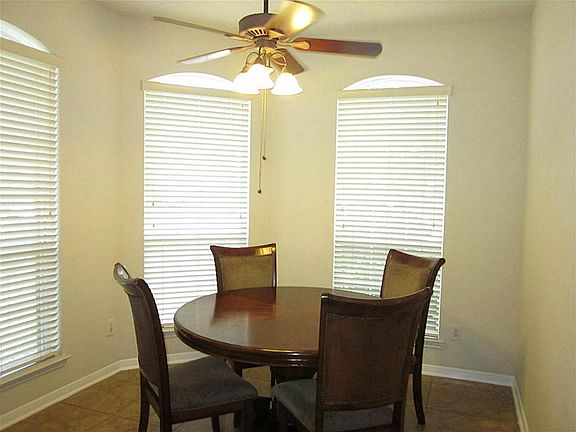 Large windows frame the charming breakfast area, which offeres ceramic tile flooring, and ceiling fan with light fixture. Great for informal meals or morning coffee!