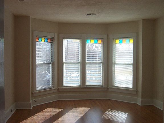 Spacious living room with bay windows, views, wood floors, h