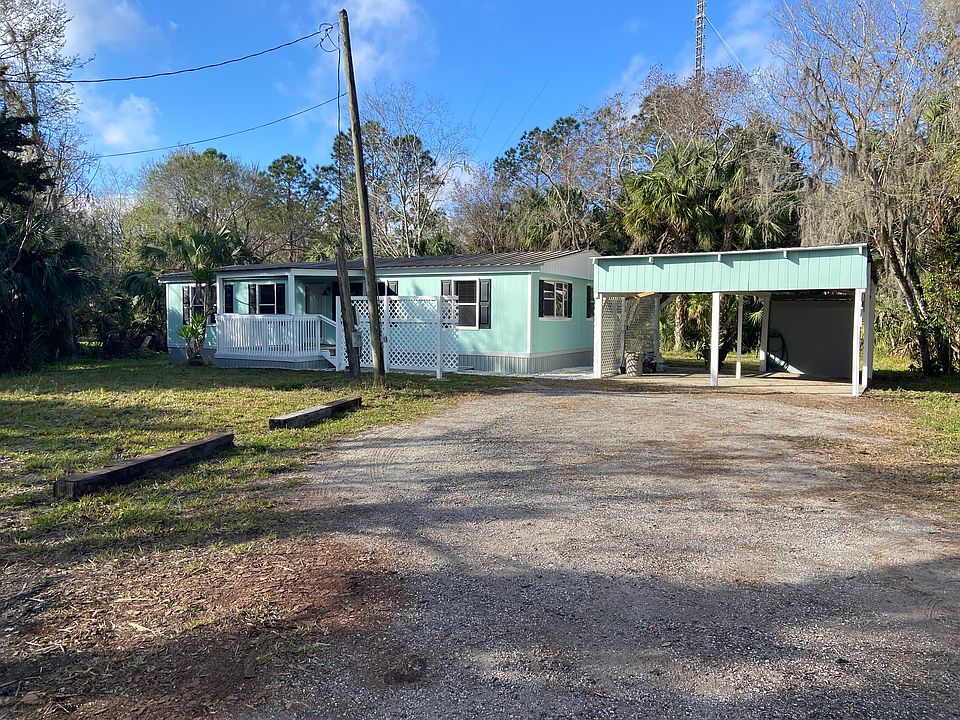 Front of house with porch and detached carport