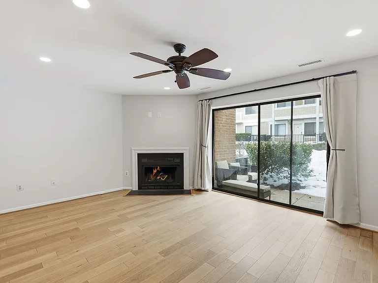 living area with fireplace and patio view