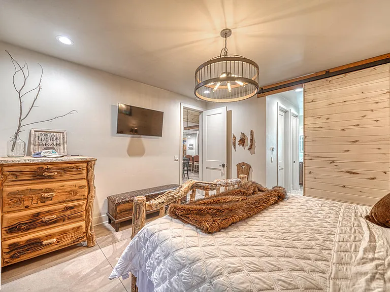 Close off the bath with the barn door. This suite hosts a tv as well as an ensuite bath.