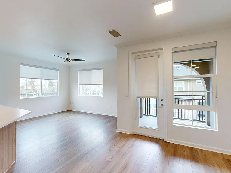 Apartment living room with wood style floor and balcony.