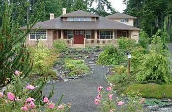Lush landscaping at entrance to craftsman -Style home