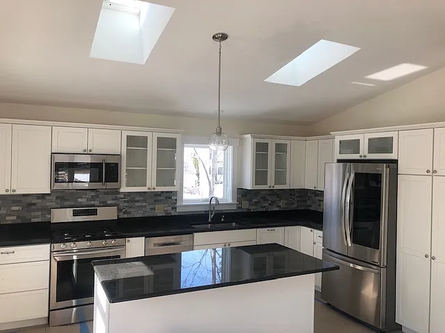 Kitchen With Granite Countertops, Stainless Steel Appliances, Skylites