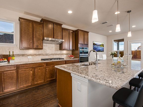 Spacious kitchen with pendant lighting and window