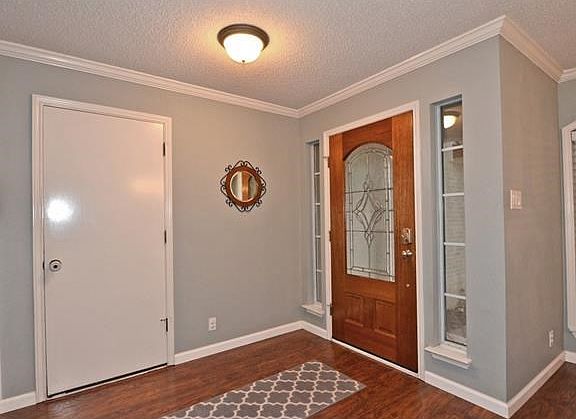 This warm and inviting foyer, with wood like flooring and crown molding, will make all of your guests feel at home from the minute they walk in the door. You will always know who is at your door with these very functional and stylish side light windows.